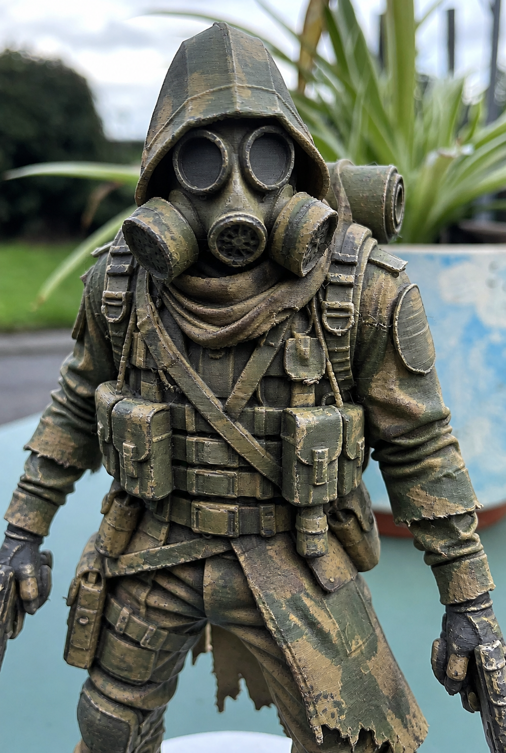 Painted 3D printed figurine of a soldier in a gas mask and long coat