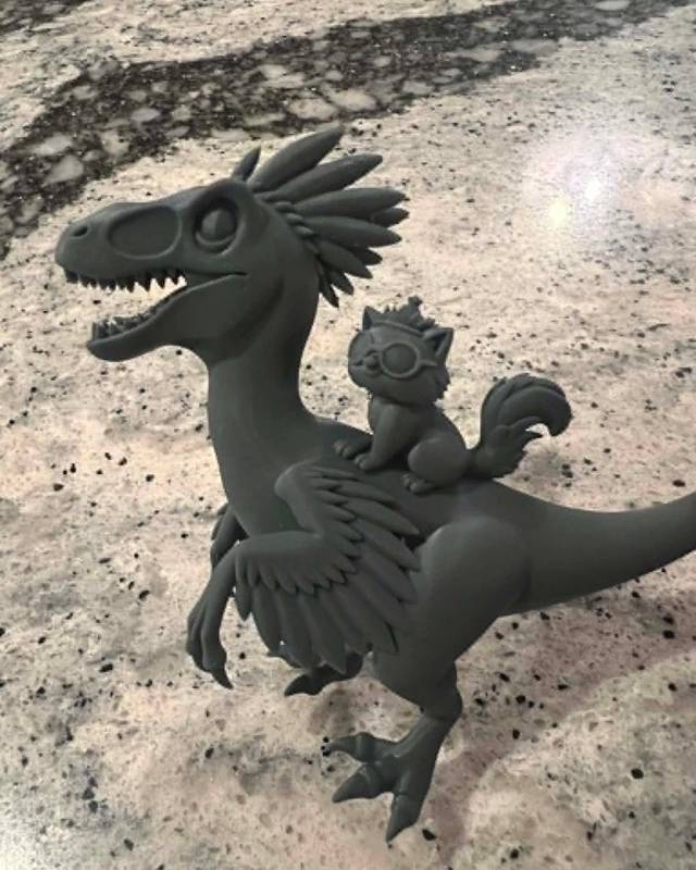 Grey resin 3D print of a velociraptor with a squirrel riding on its back